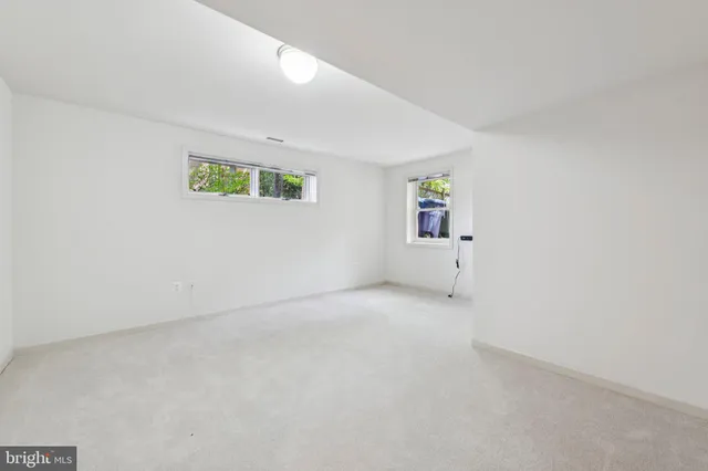 an empty room with painting on the wall