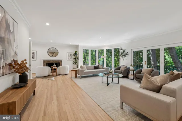 a living room with furniture and large windows