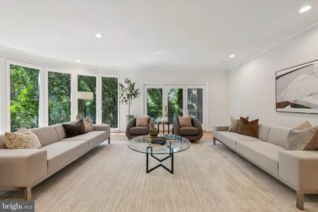 a living room with furniture and large windows