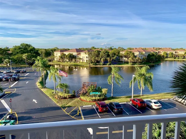 swimming pool view with plants and large trees