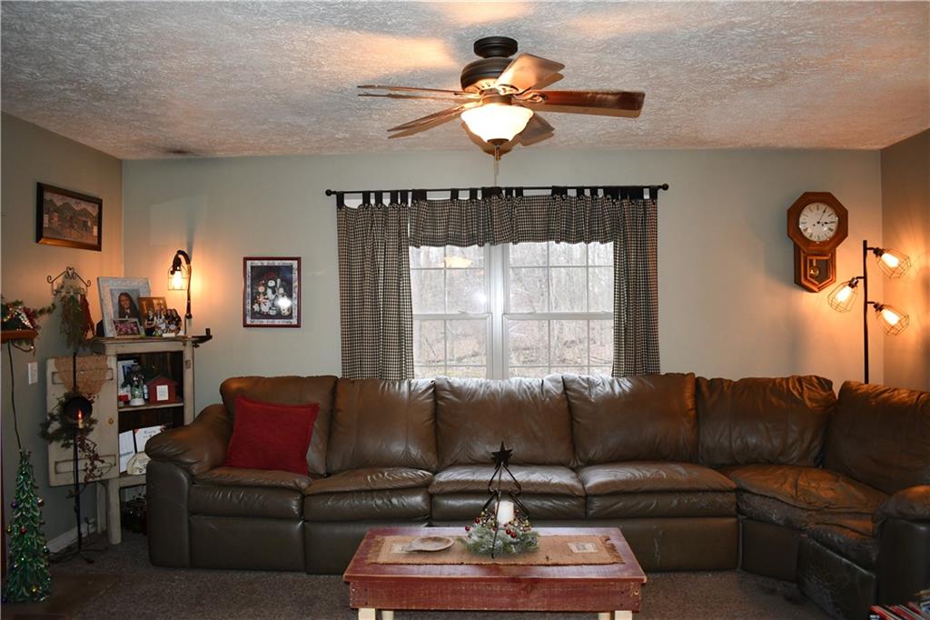 74 Tr784 Burgettstown, PA 15021 - Photo 16 of 22 a living room with furniture ceiling fan and a window