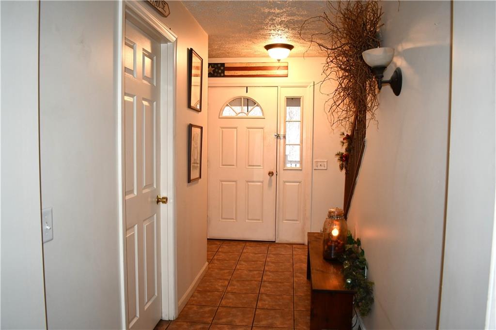 74 Tr784 Burgettstown, PA 15021 - Photo 3 of 22 a bathroom with a granite countertop shower a mirror and a sink
