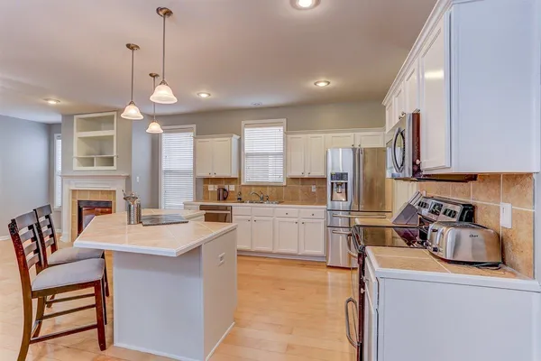 a kitchen with a sink appliances and cabinets