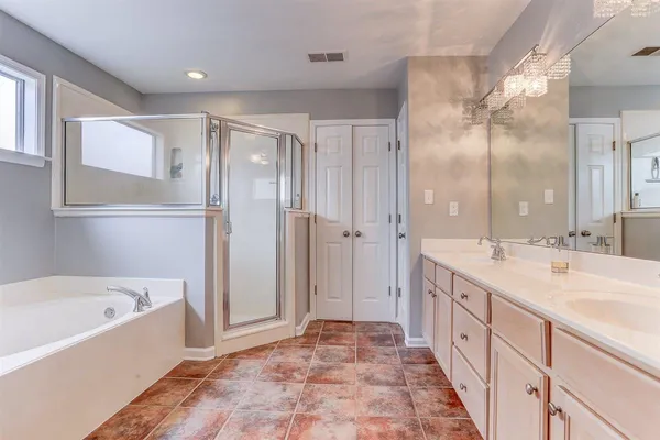 a bathroom with a bathtub shower and sink