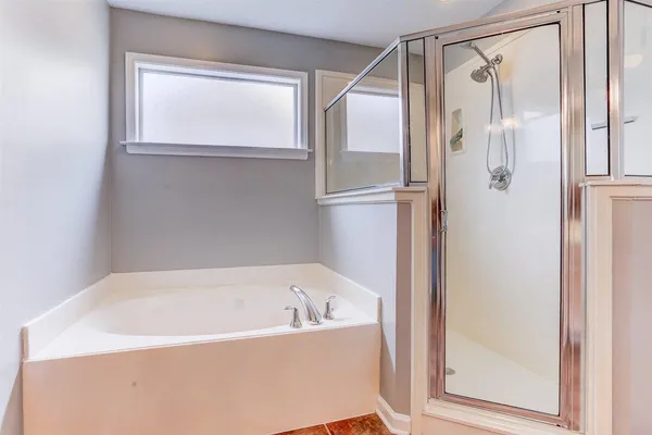 a bathroom with a bathtub and a shower