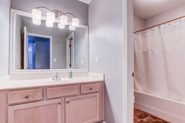 a bathroom with a sink vanity and a mirror