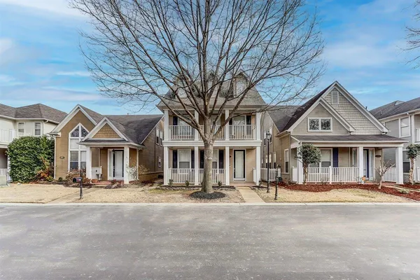 a front view of a building with a yard