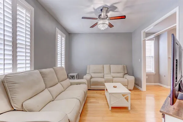 a living room with furniture and wooden floor