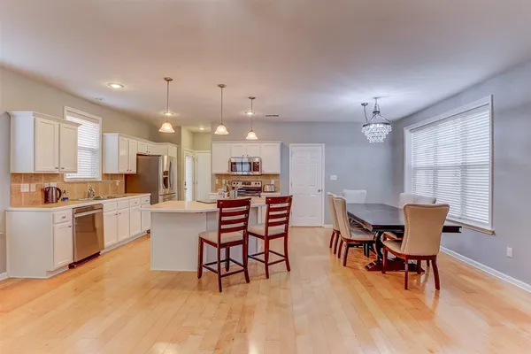 a view of a dining room with furniture and chandelier
