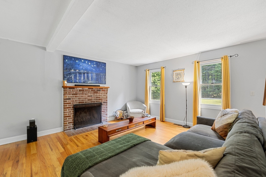 5 Friends Way Pepperell, MA 01463 - Photo 13 of 29 a bedroom with a bed and a fireplace