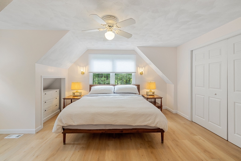 5 Friends Way Pepperell, MA 01463 - Photo 15 of 29 a bedroom with a bed and a chandelier