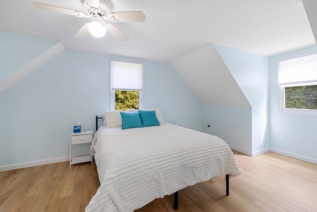 5 Friends Way Pepperell, MA 01463 - Photo 16 of 29 a bedroom with a bed and a chandelier