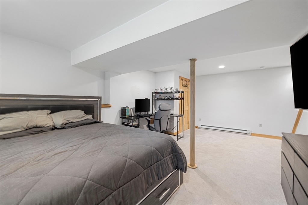 5 Friends Way Pepperell, MA 01463 - Photo 21 of 29 a bedroom with a bed and a flat screen tv