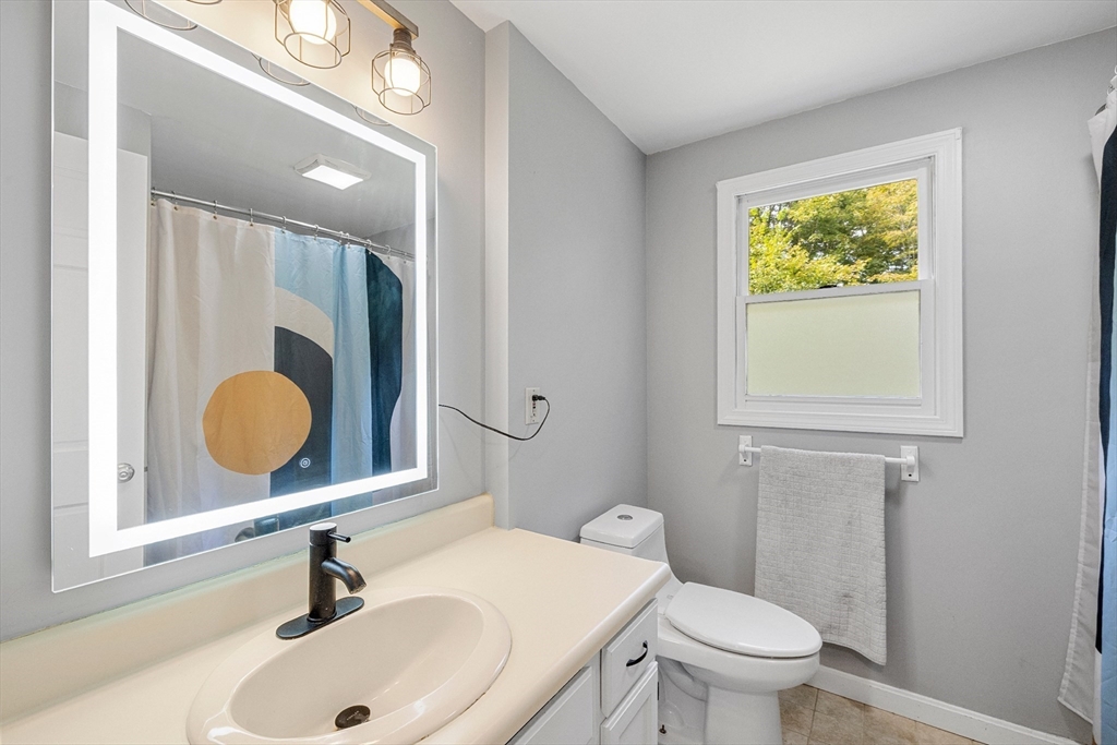 5 Friends Way Pepperell, MA 01463 - Photo 22 of 29 a bathroom with a sink mirror vanity and toilet