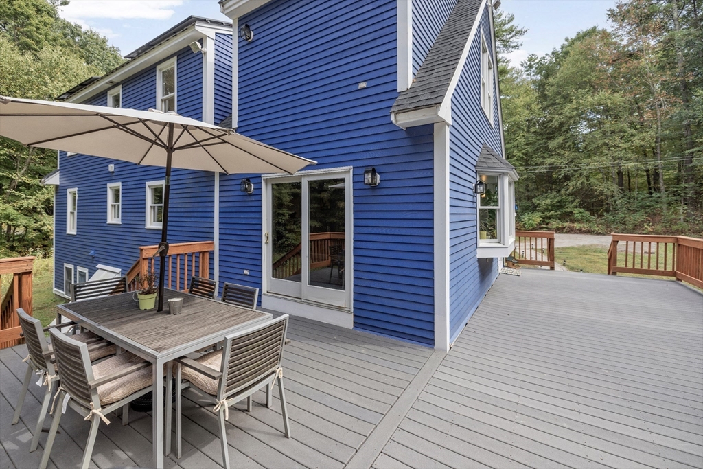 5 Friends Way Pepperell, MA 01463 - Photo 24 of 29 a backyard of a house with wooden table and chairs