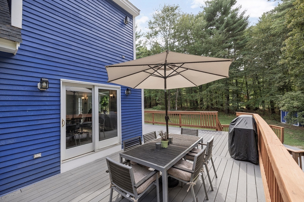 5 Friends Way Pepperell, MA 01463 - Photo 25 of 29 a patio with wooden floor a yard a table and chairs