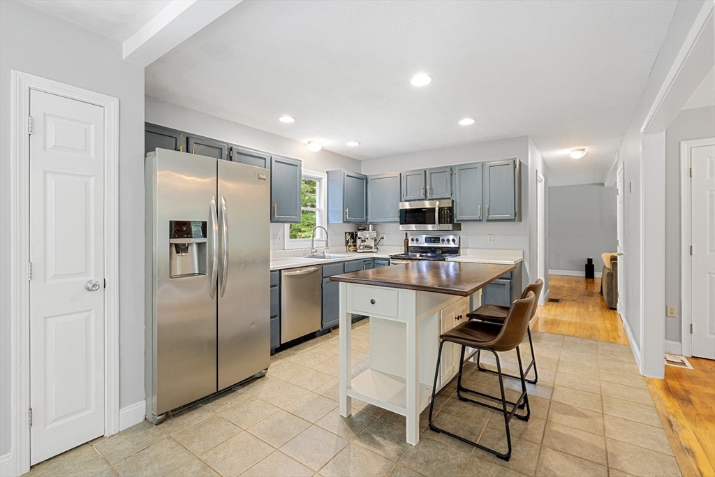 5 Friends Way Pepperell, MA 01463 - Photo 3 of 29 a kitchen with stainless steel appliances a refrigerator sink and cabinets