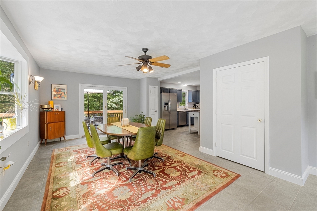 5 Friends Way Pepperell, MA 01463 - Photo 7 of 29 a living room with a couch dining table and a large window