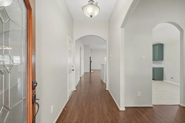a view of a hallway with wooden floor