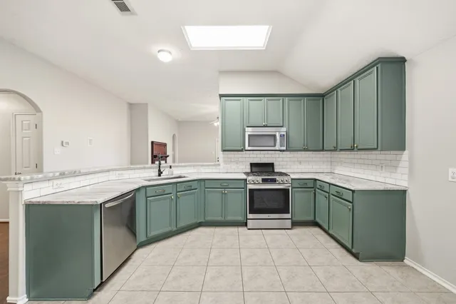 a kitchen with stainless steel appliances granite countertop a sink counter space cabinets and a sink