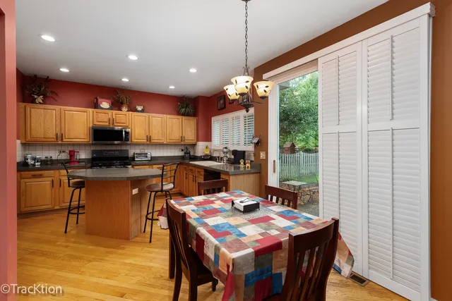 a kitchen with a table chairs sink stove and refrigerator