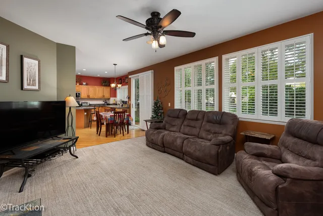 a living room with furniture and a flat screen tv with wooden floor