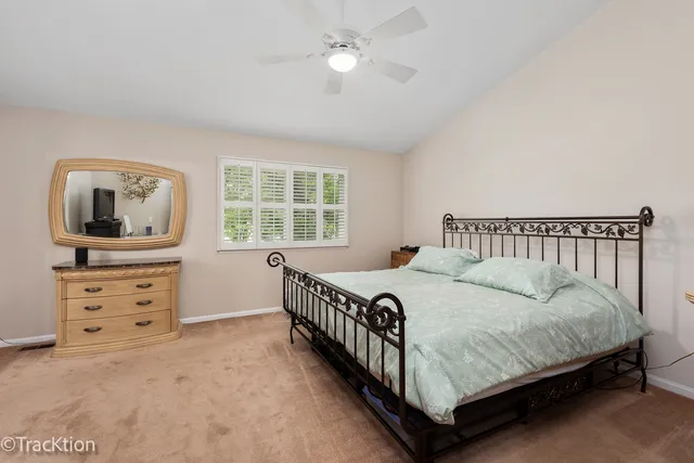 a bedroom with a bed window and a dresser