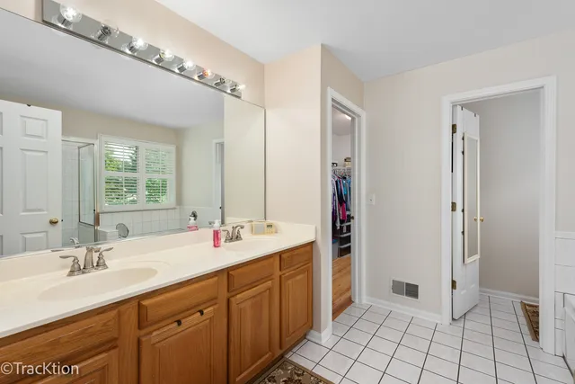 a bathroom with a sink double vanity and a mirror