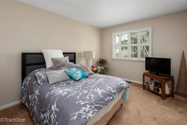 a bedroom with a bed and flat screen tv