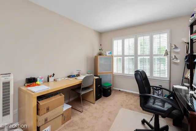 a view of a workspace with furniture and a window
