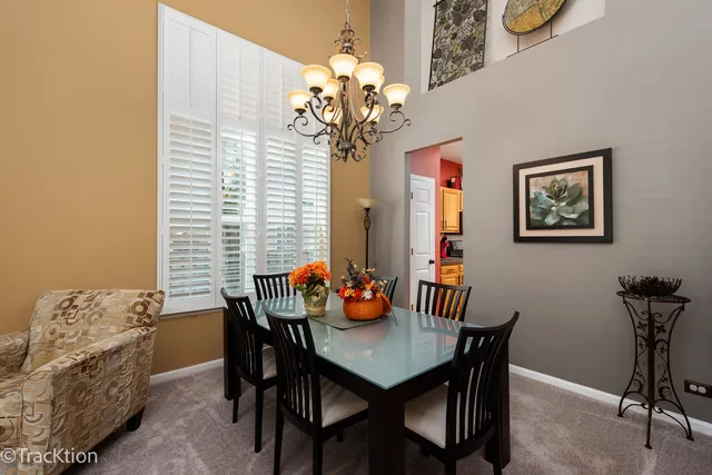a view of a dining room with furniture and a chandelier