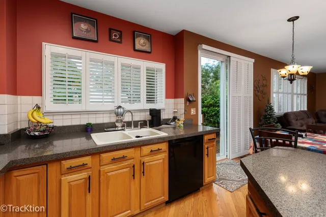 a kitchen with stainless steel appliances granite countertop sink stove and wooden cabinets