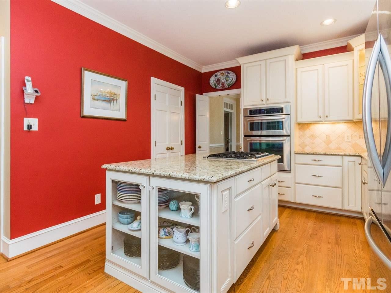 1804 Banbury Road Raleigh, NC 27608 - Photo 11 of 25 a kitchen with stainless steel appliances granite countertop a stove and a refrigerator