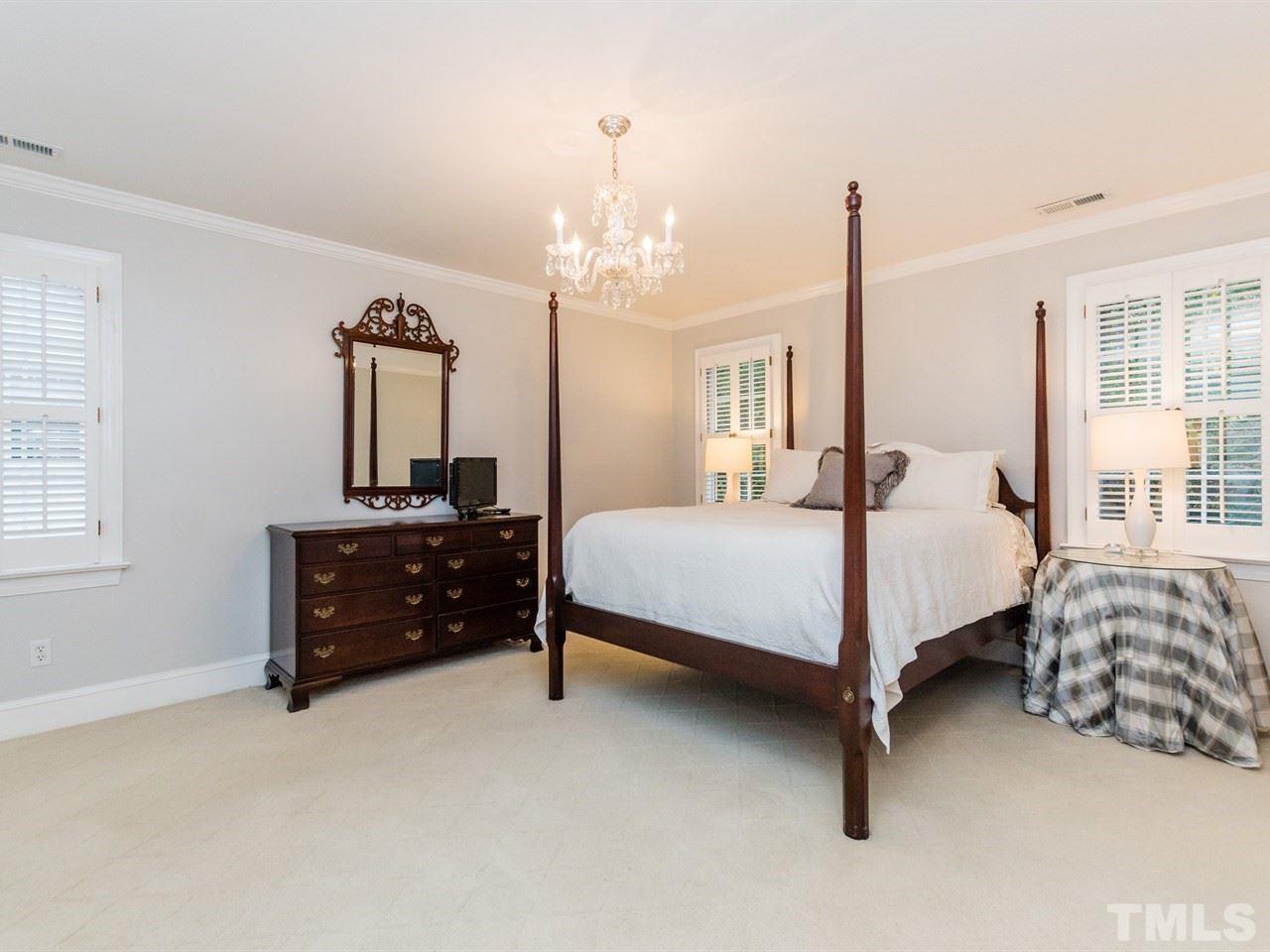 1804 Banbury Road Raleigh, NC 27608 - Photo 14 of 25 a bedroom with a bed and a chandelier