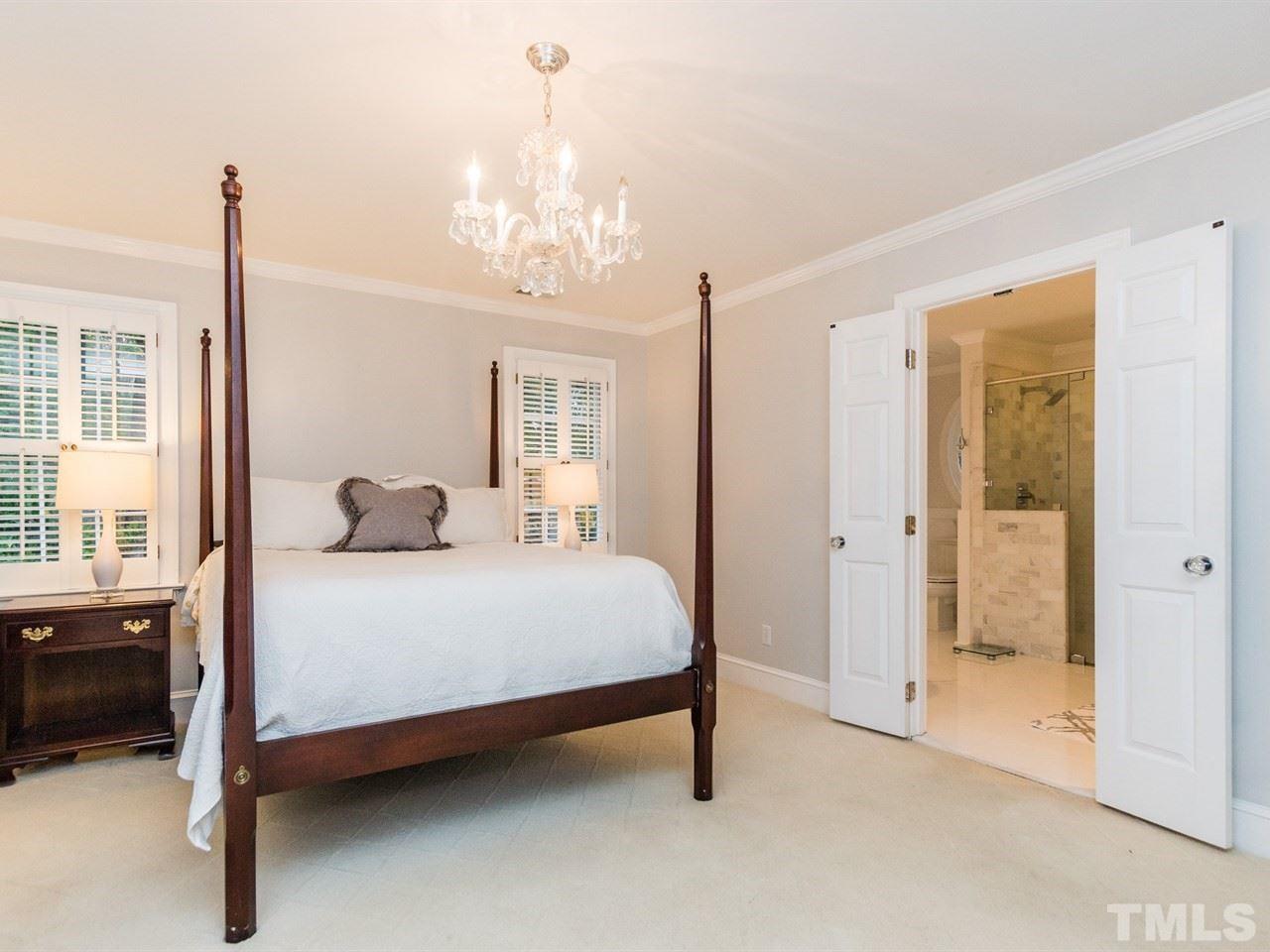 1804 Banbury Road Raleigh, NC 27608 - Photo 15 of 25 a bedroom with a bed and a chandelier