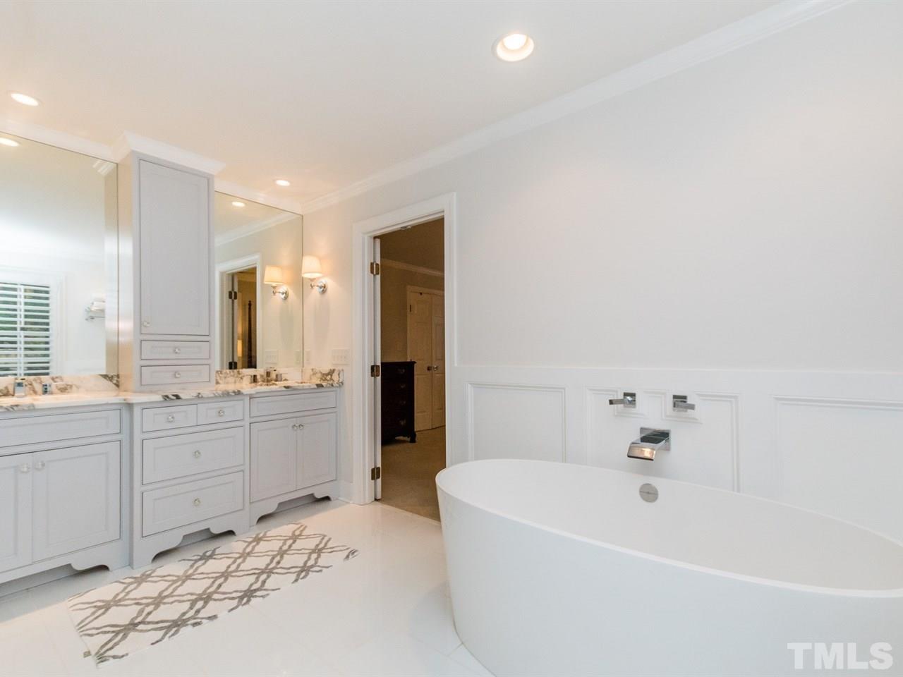 1804 Banbury Road Raleigh, NC 27608 - Photo 17 of 25 a large spacious bathroom with a tub sink and mirror