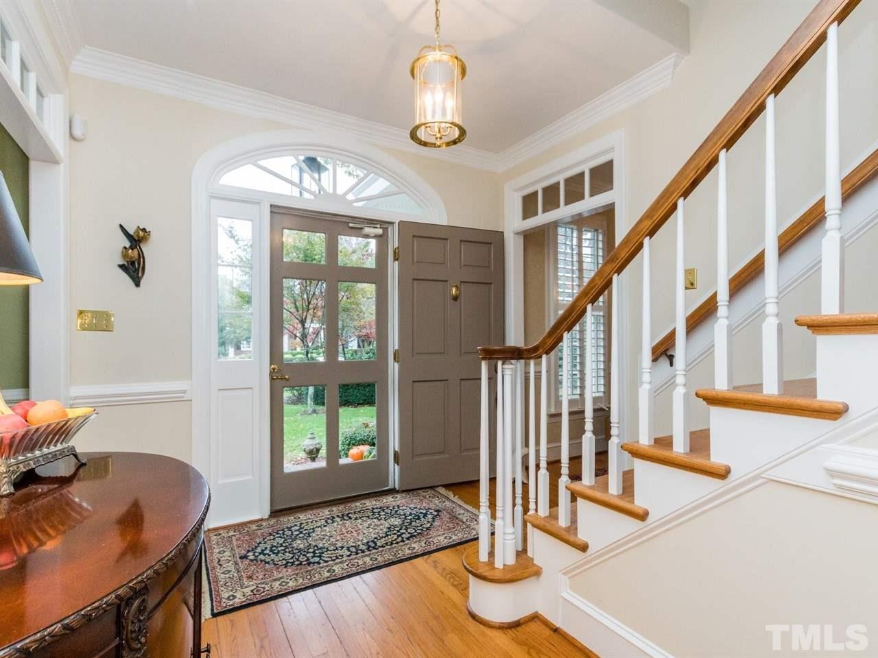 1804 Banbury Road Raleigh, NC 27608 - Photo 3 of 25 a view of entryway with wooden floor and a chandelier
