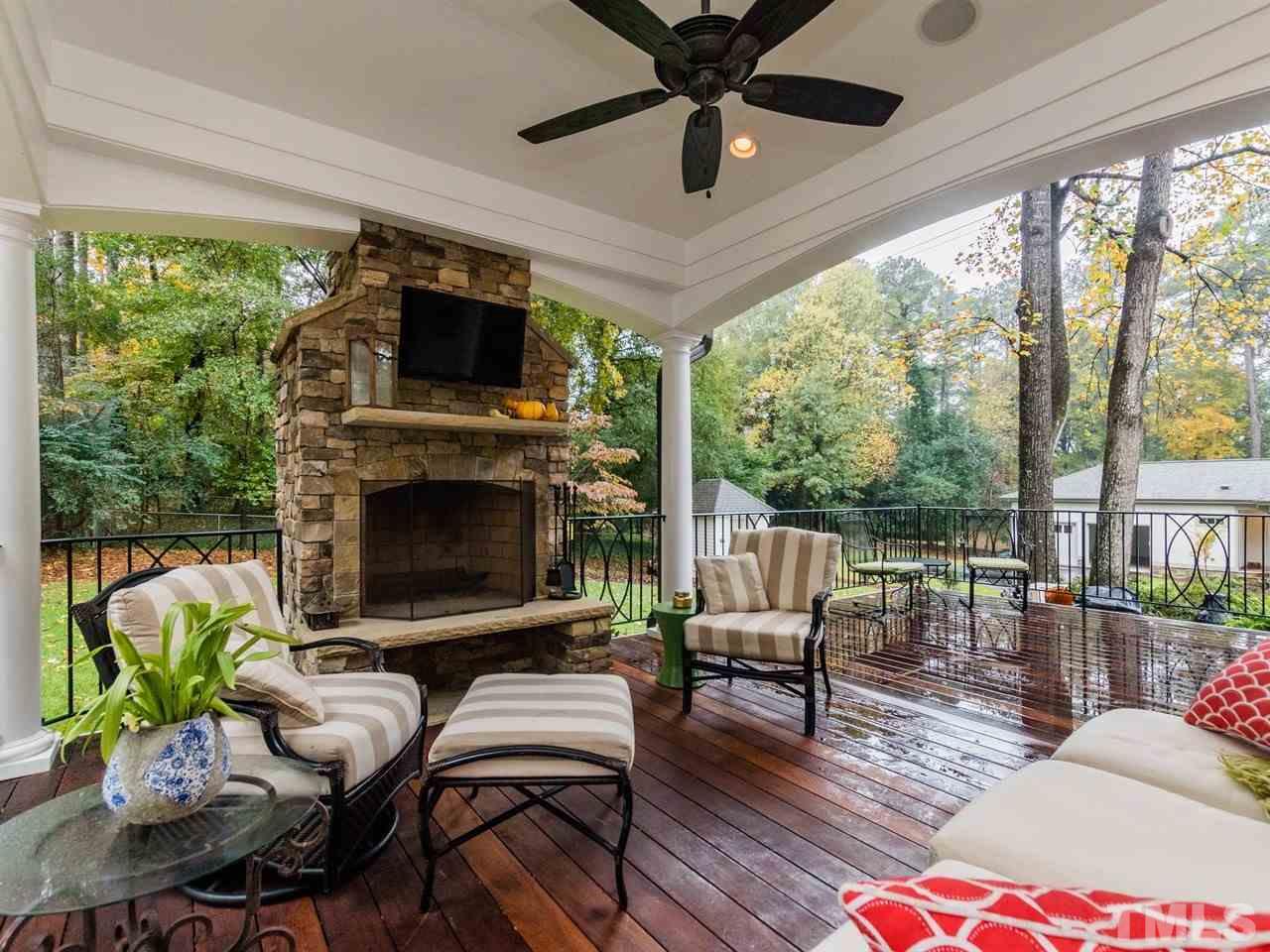 1804 Banbury Road Raleigh, NC 27608 - Photo 22 of 25 a living room with furniture a flat screen tv and a fireplace