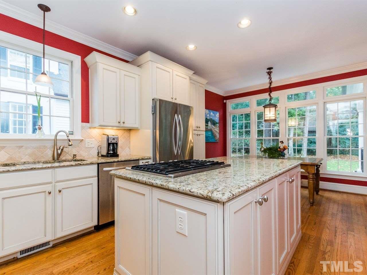 1804 Banbury Road Raleigh, NC 27608 - Photo 9 of 25 a kitchen with stainless steel appliances granite countertop a stove a sink dishwasher and a refrigerator