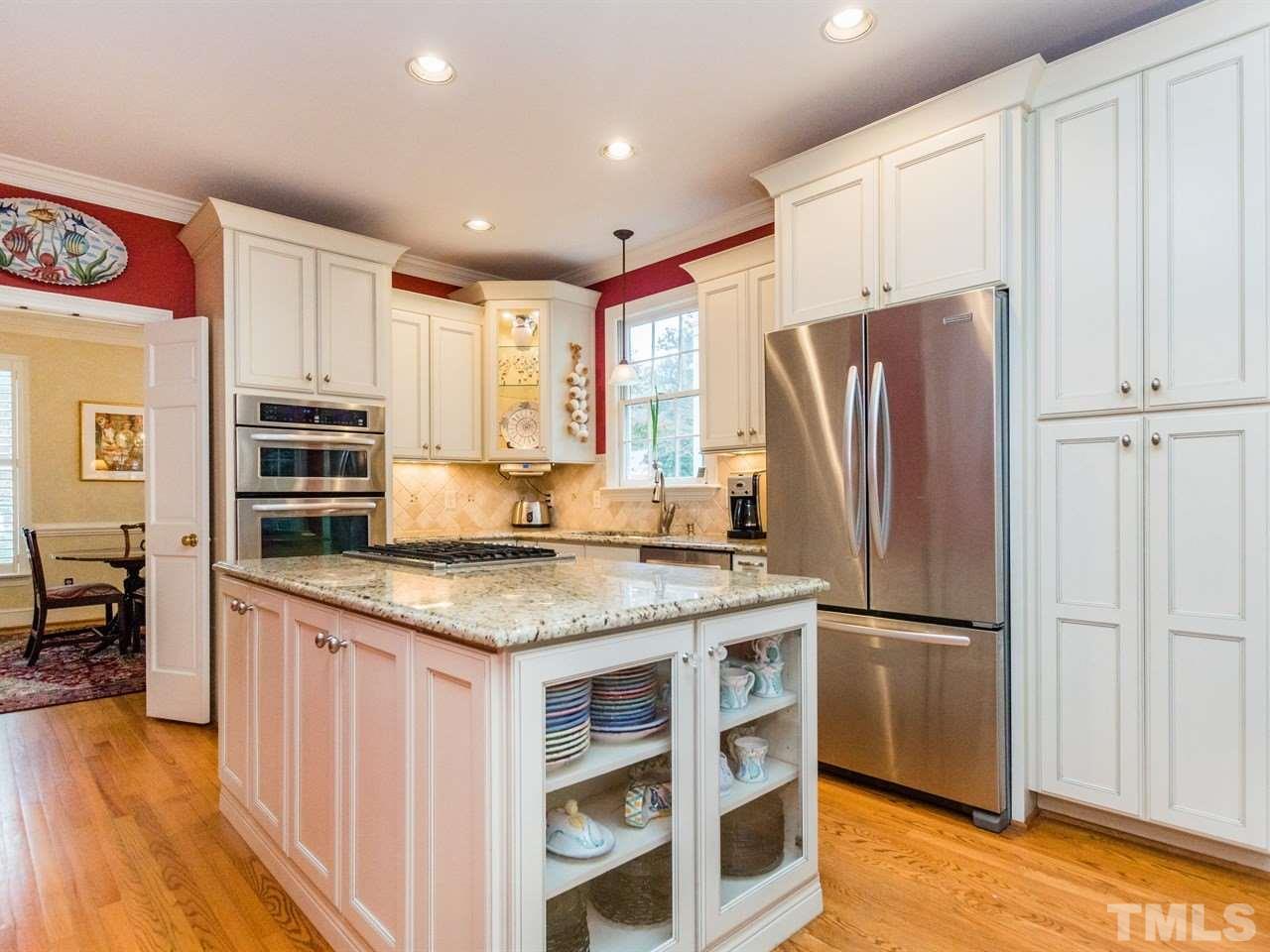 1804 Banbury Road Raleigh, NC 27608 - Photo 10 of 25 a kitchen with stainless steel appliances granite countertop a refrigerator a stove and a sink