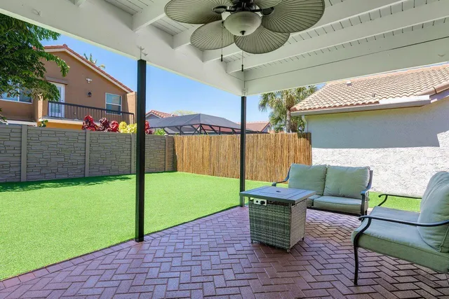 a view of a park that has a sign board large trees