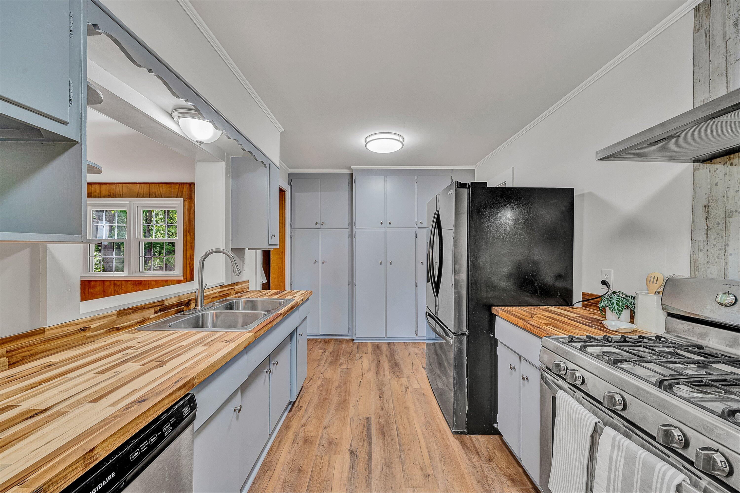 730 Texas Hollow Road Salem, VA 24153 - Photo 15 of 39 a kitchen with stainless steel appliances hardwood floor sink stove and refrigerator
