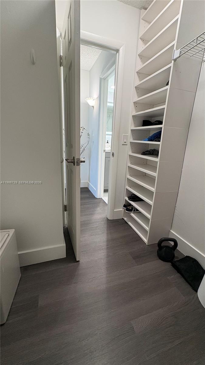 299 Northwest 52nd Terrace, Unit PHX Boca Raton, FL 33487 - Photo 4 of 29 a view of a room with stairs and a wooden floor