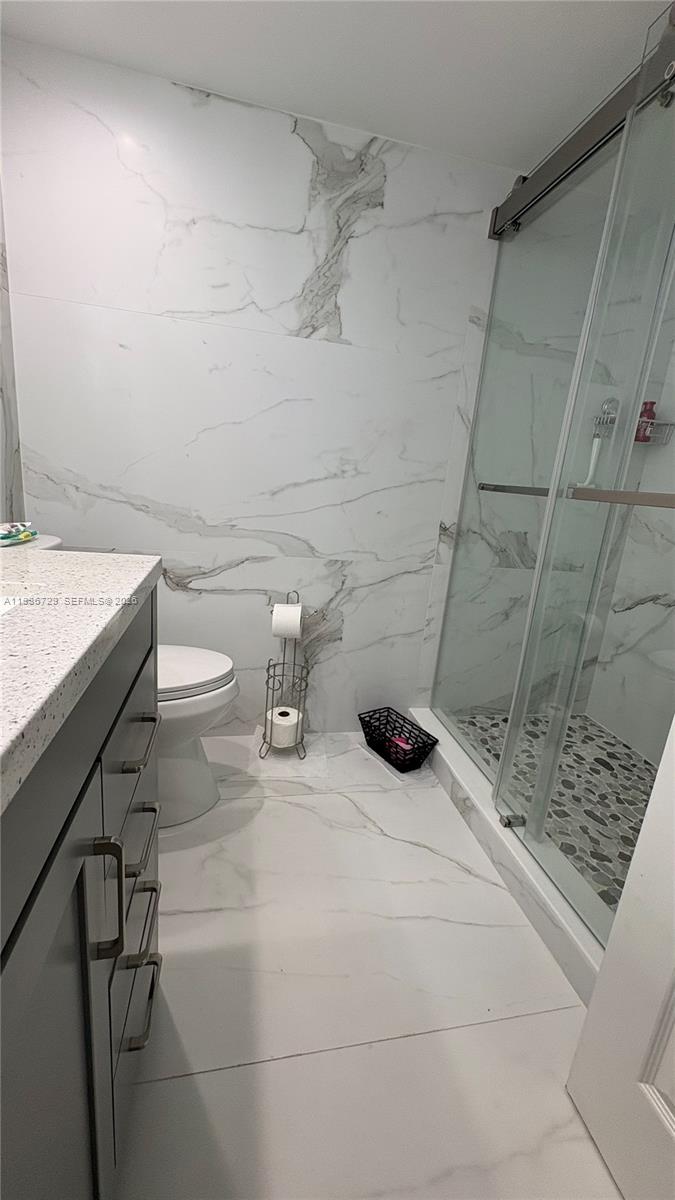 299 Northwest 52nd Terrace, Unit PHX Boca Raton, FL 33487 - Photo 6 of 29 a bathroom with a sink and a toilet