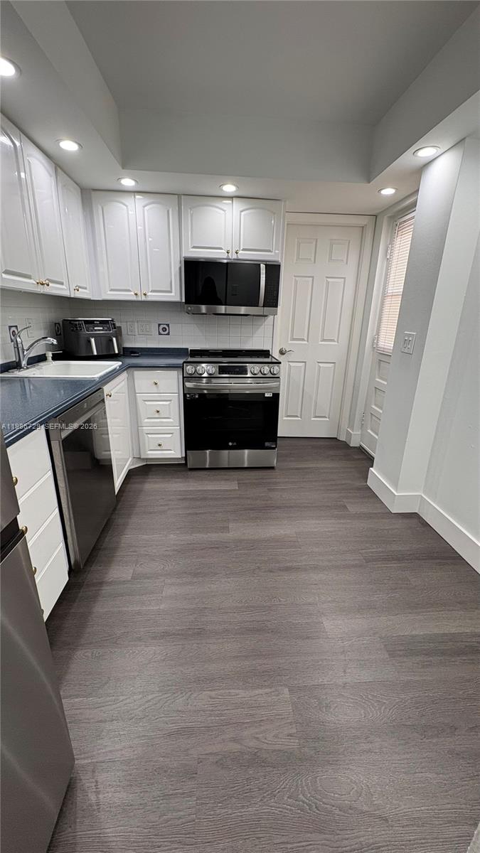 299 Northwest 52nd Terrace, Unit PHX Boca Raton, FL 33487 - Photo 8 of 29 a kitchen with granite countertop a refrigerator and a stove top oven