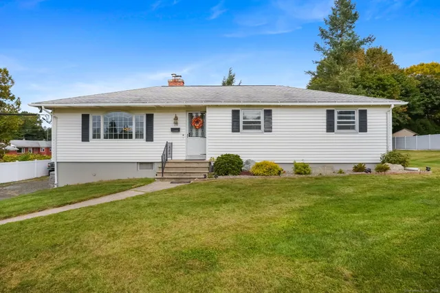 a front view of house with yard and trees