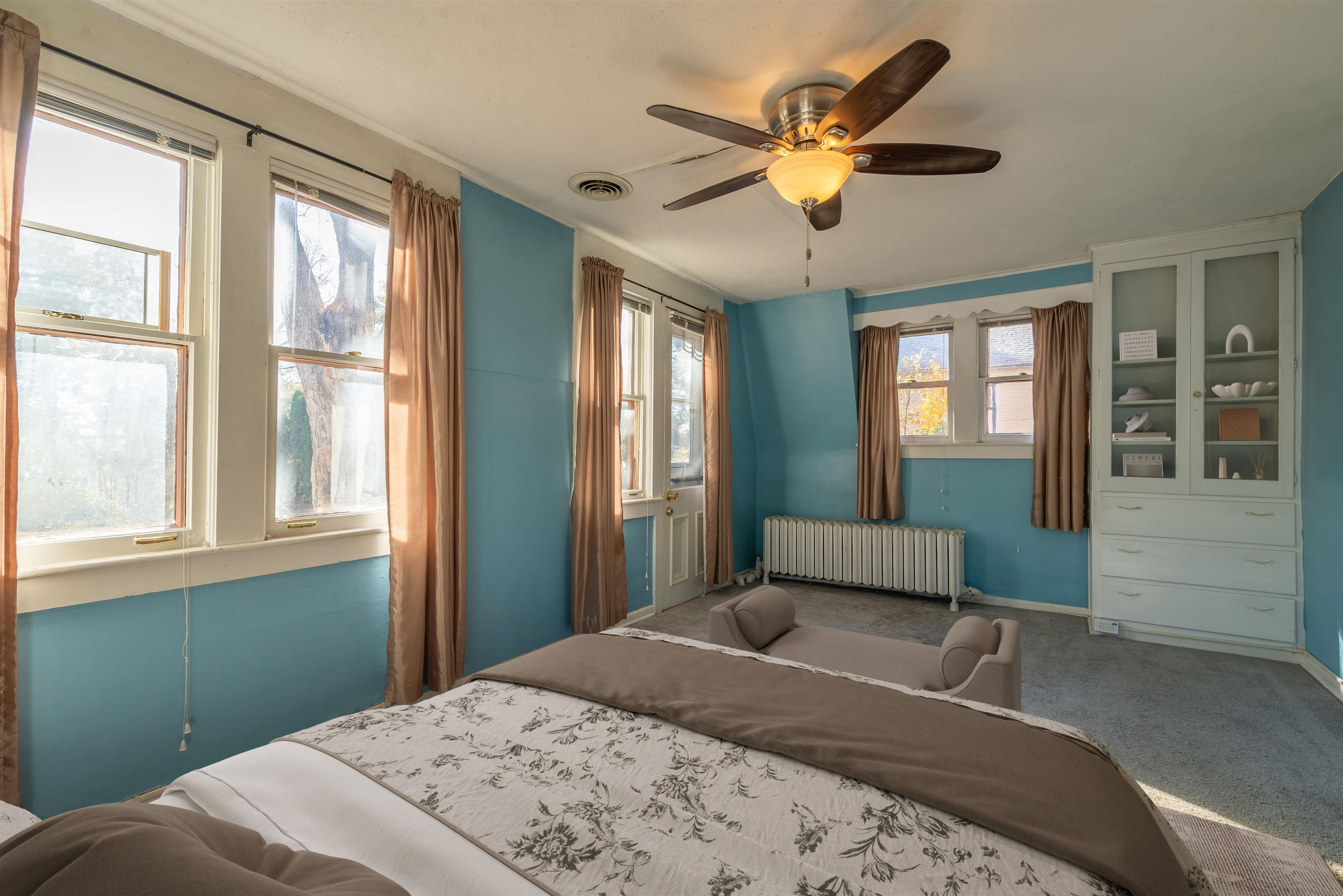 933 West Stephenson Street Freeport, IL 61032 - Photo 28 of 32 a bedroom with a large bed chandelier and a window