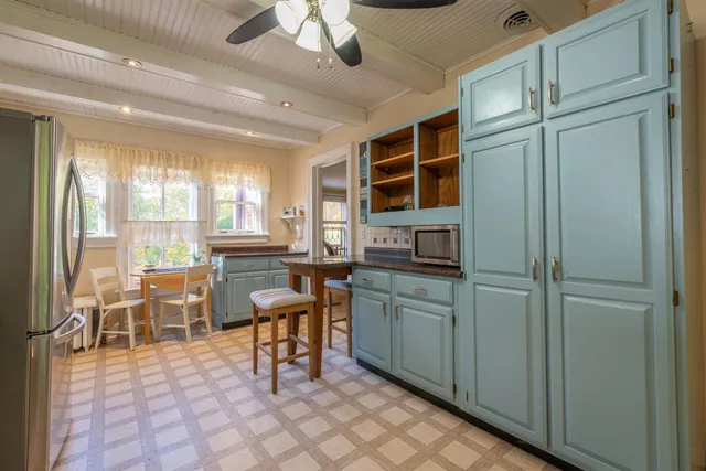 a kitchen with stainless steel appliances granite countertop a refrigerator and a stove top oven