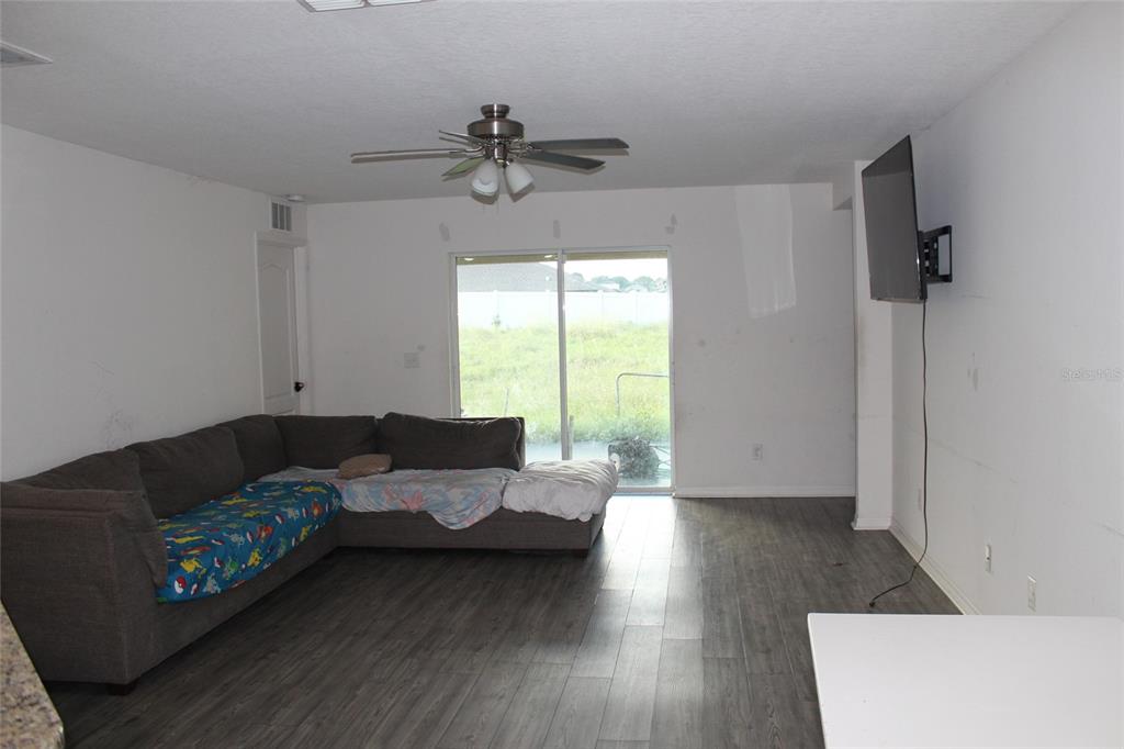 1733 Canaan Loop Dundee, FL 33838 - Photo 14 of 16 a living room with furniture and a window