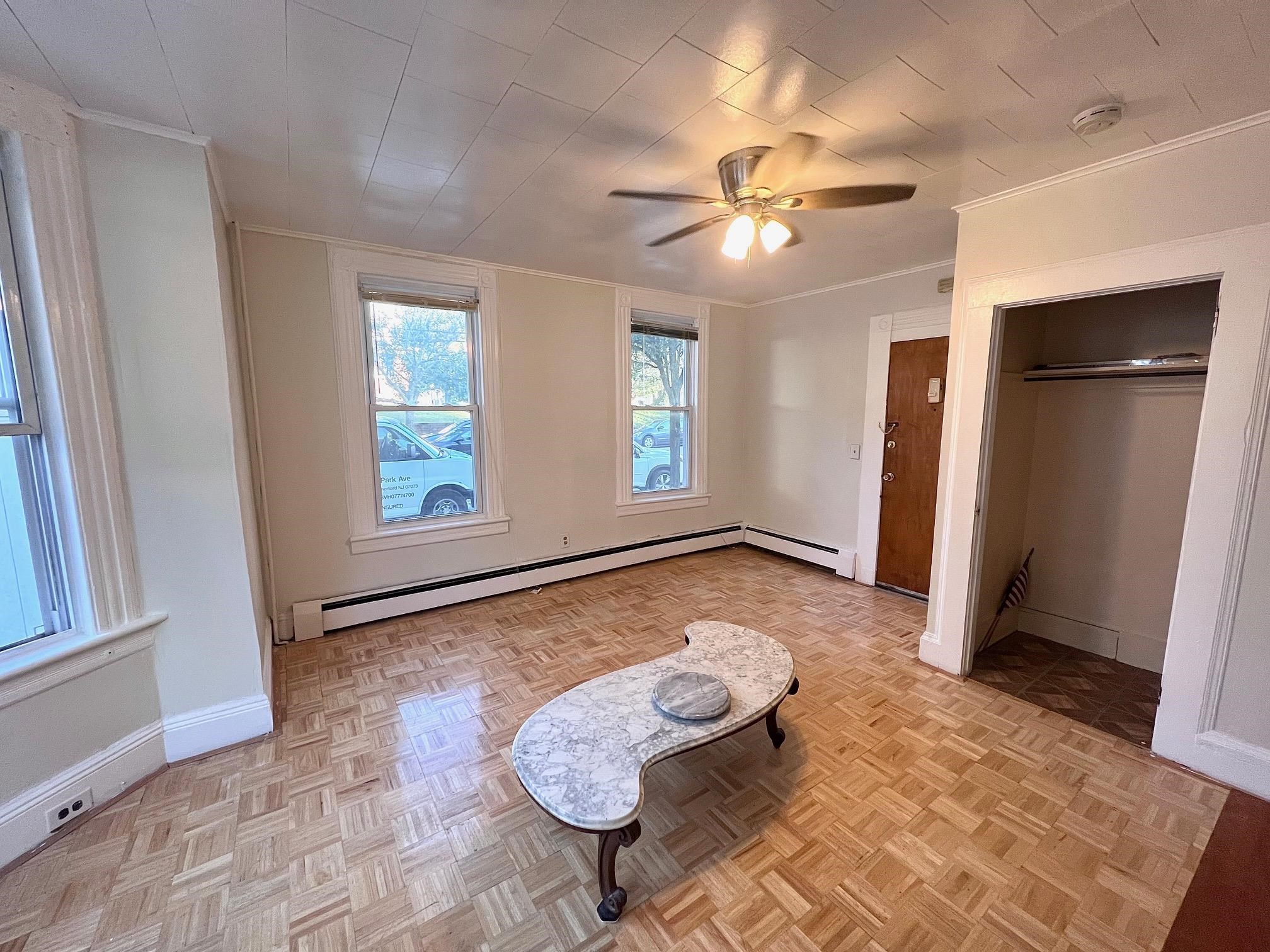 177 Park Avenue, Unit 2 East Rutherford, NJ 07073 - Photo 1 of 7 a view of a livingroom with wooden floor and window